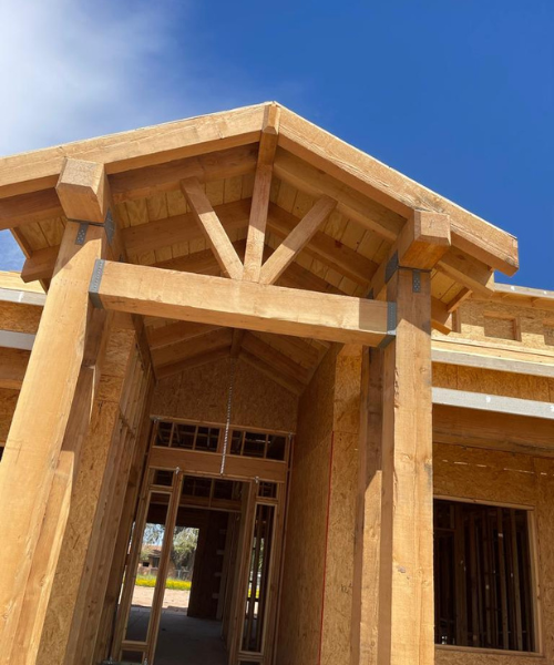 A large wooden building with a blue sky in the background