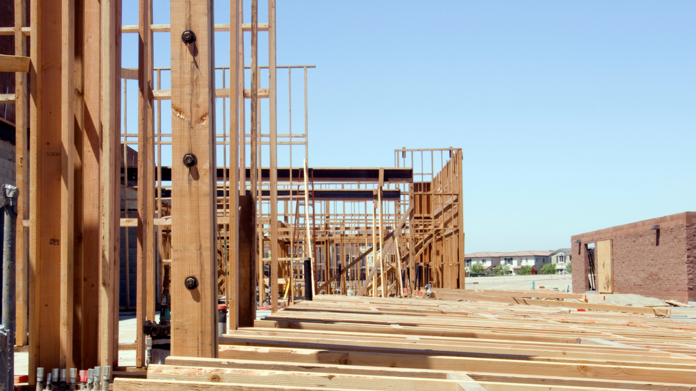 A row of wooden buildings with a sky background