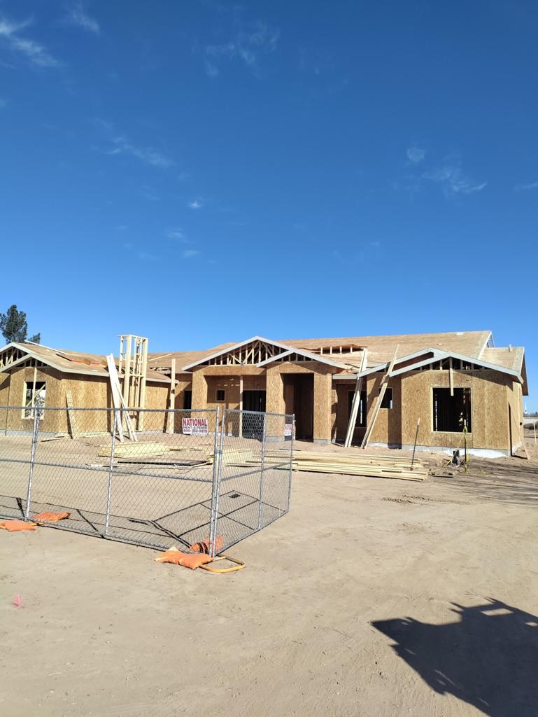 A house under construction in the middle of the day