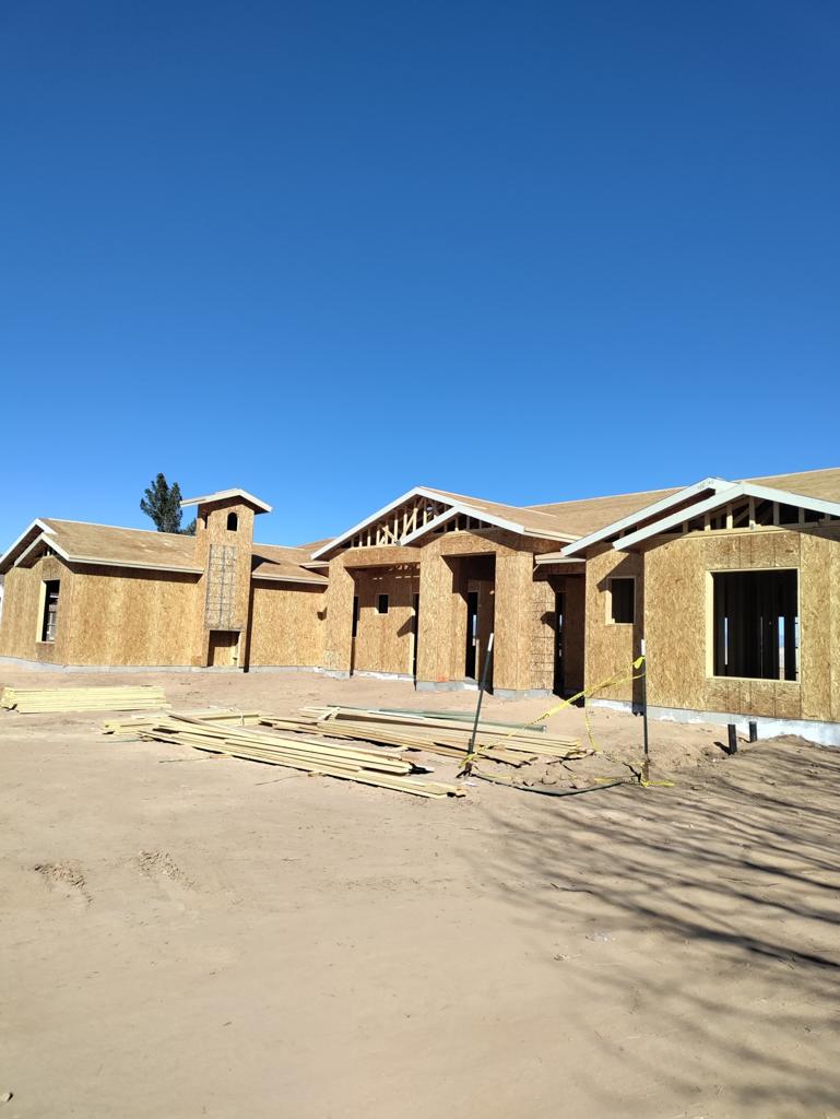 A house under construction in the middle of the day