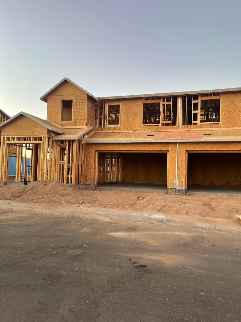 A house under construction with a lot of windows