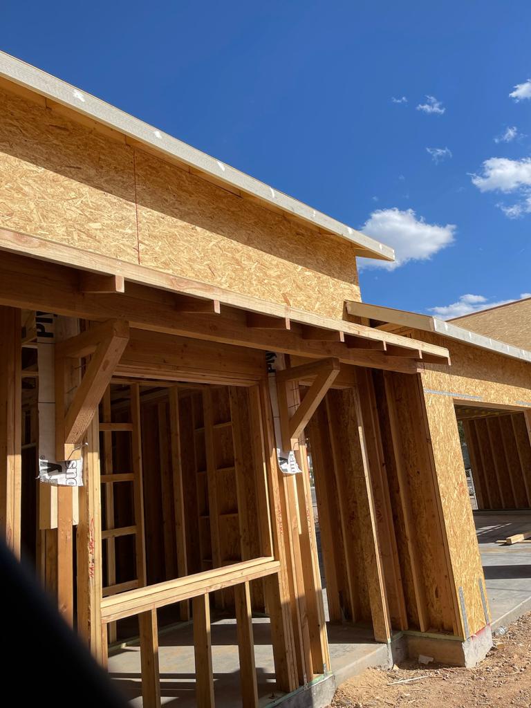 A row of wooden framed buildings under construction