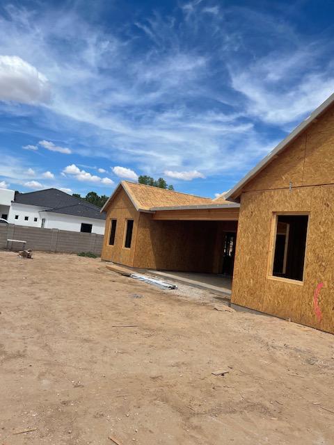 A house under construction with a blue sky in the background