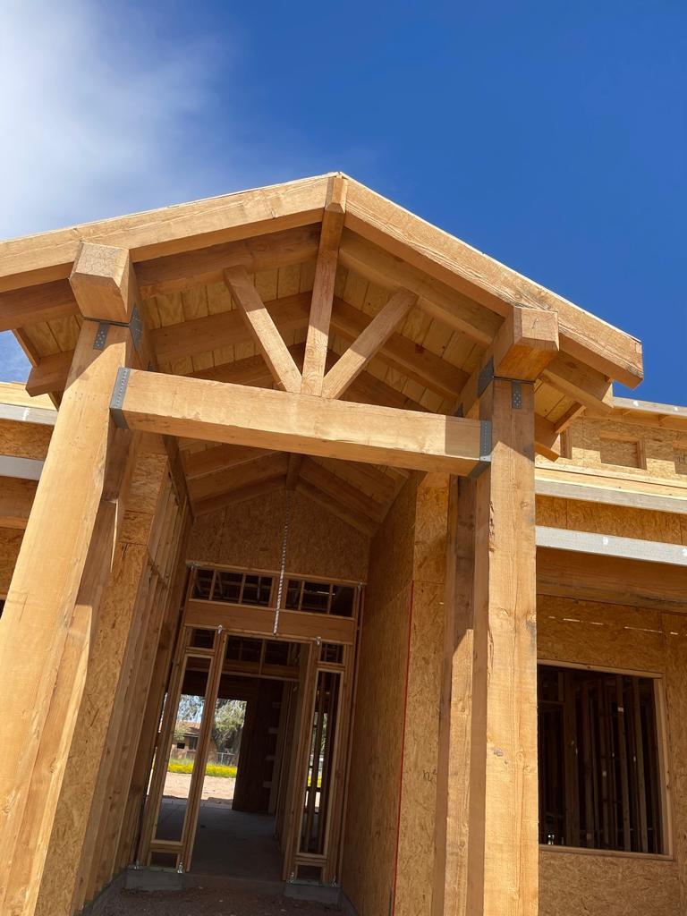 A large wooden building with a sky background