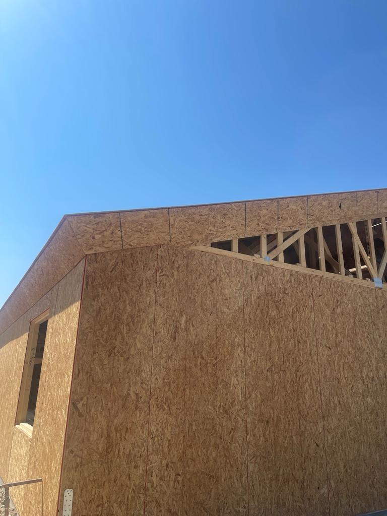 A building that is being built with a wooden roof